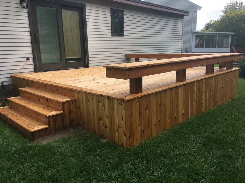 Cedar deck with a built-in bench and wide steps.