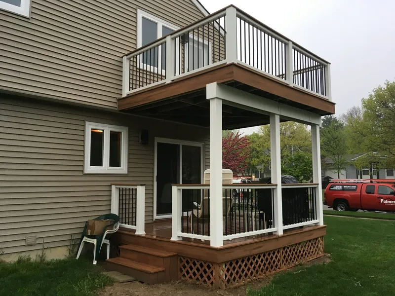 Two-story porch with white columns and a railed balcony above.